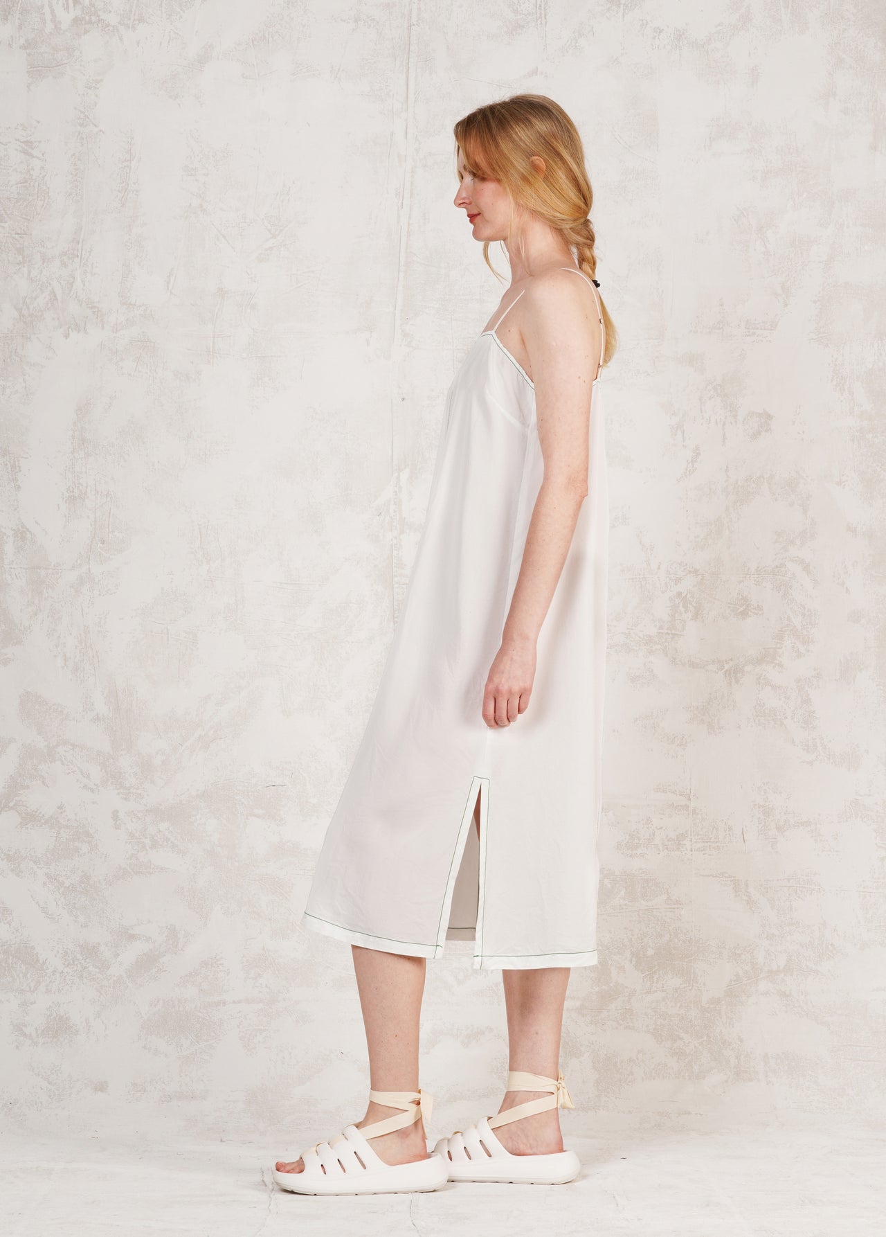 white spaghetti strap dress against neutral wall