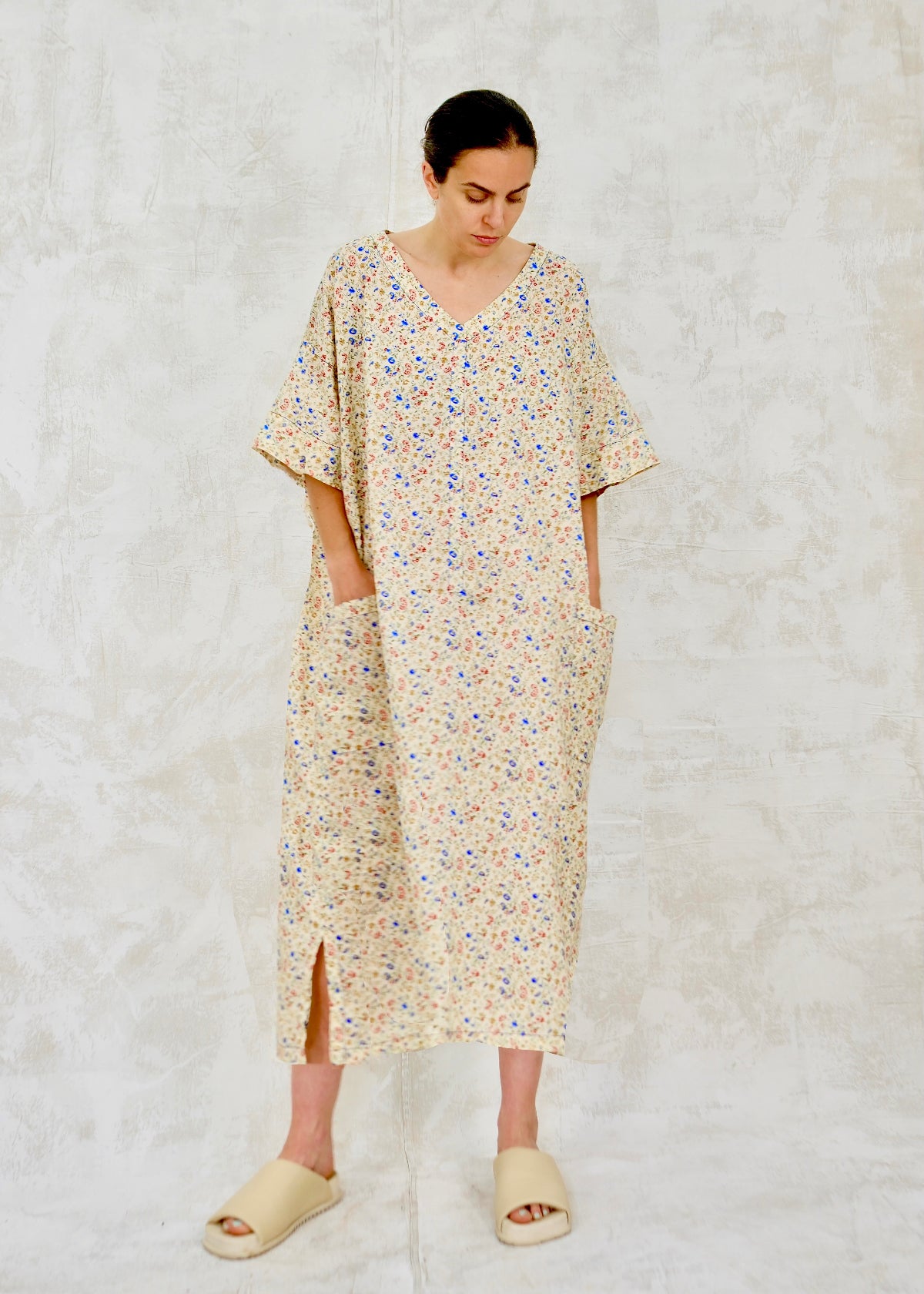 Woman wearing a floral dress on a textured white background