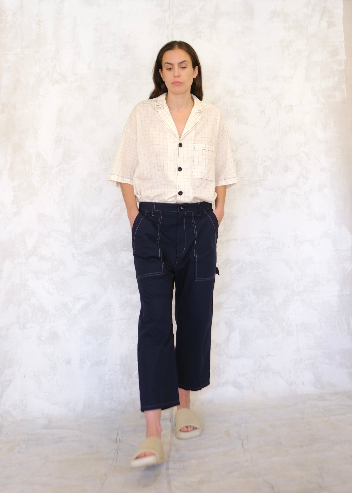 front view navy poplin pants, hands in pockets, tool loop on the side
