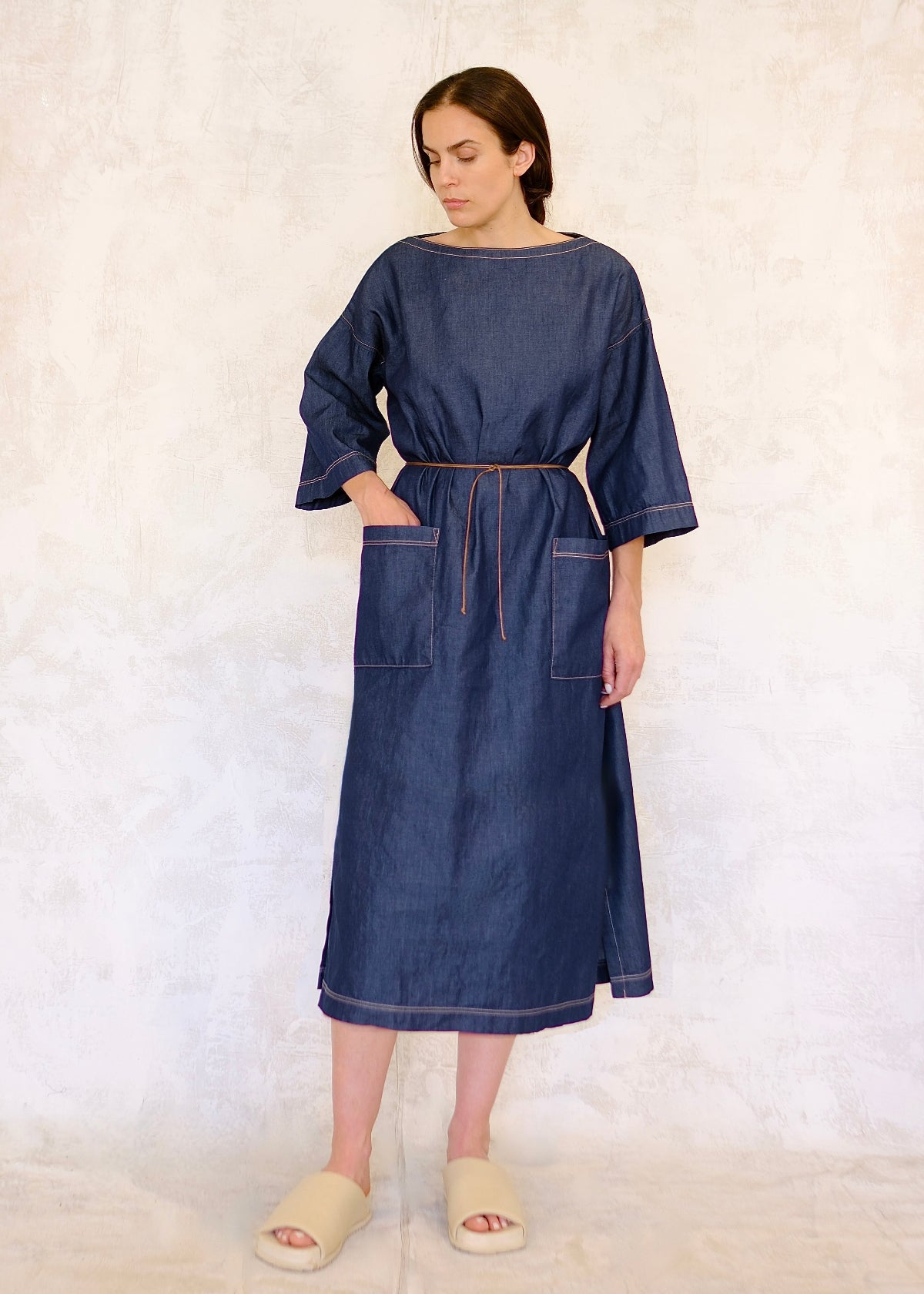 belted Denim urban garden dress on a hanger against a white background