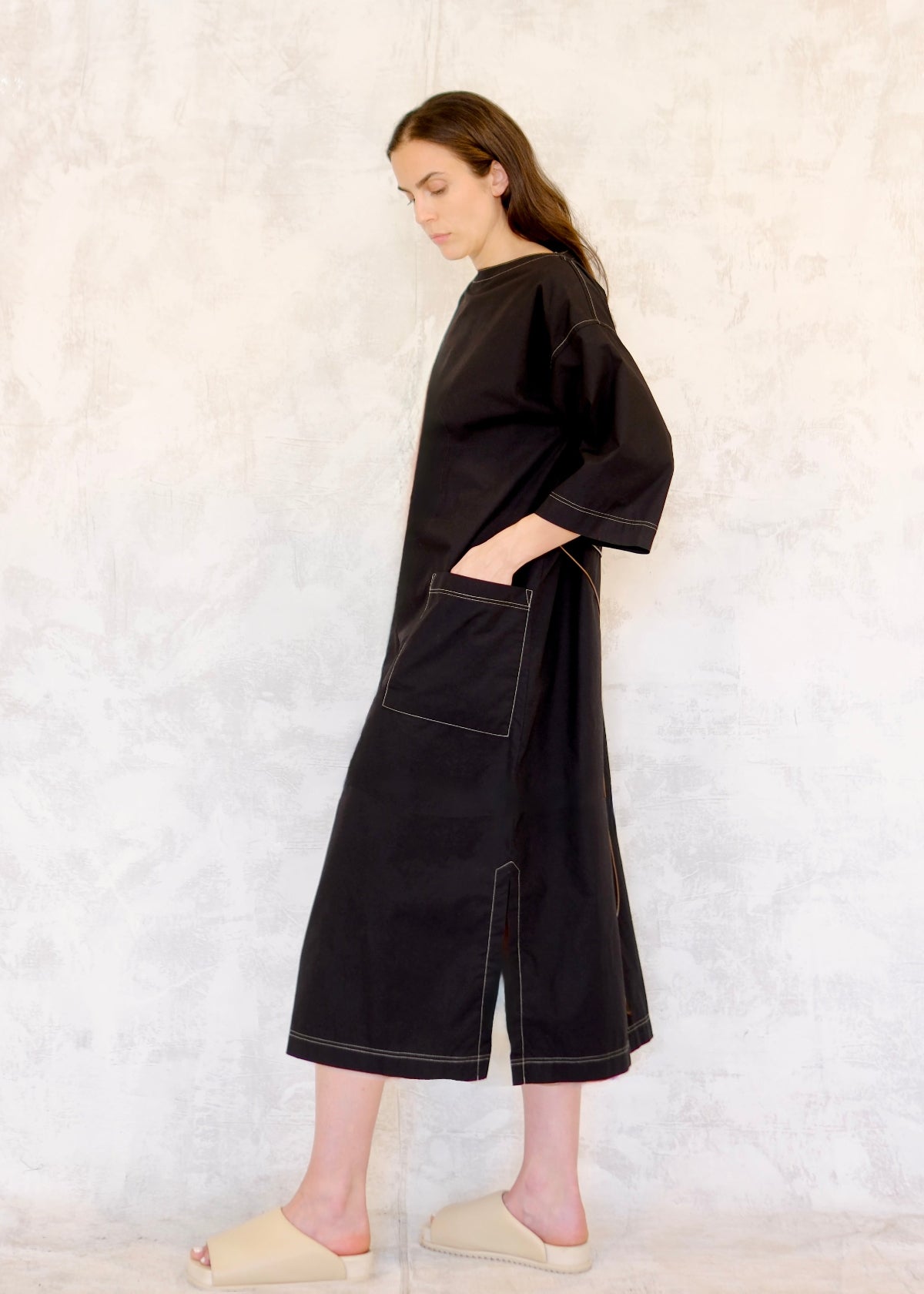Black Dress midi side view hand in pocket