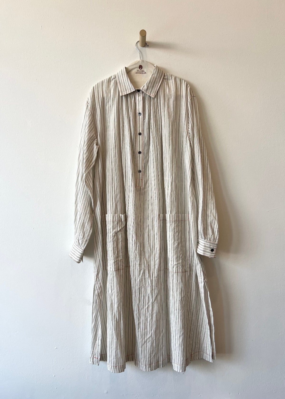 striped dress hanging against a white wall