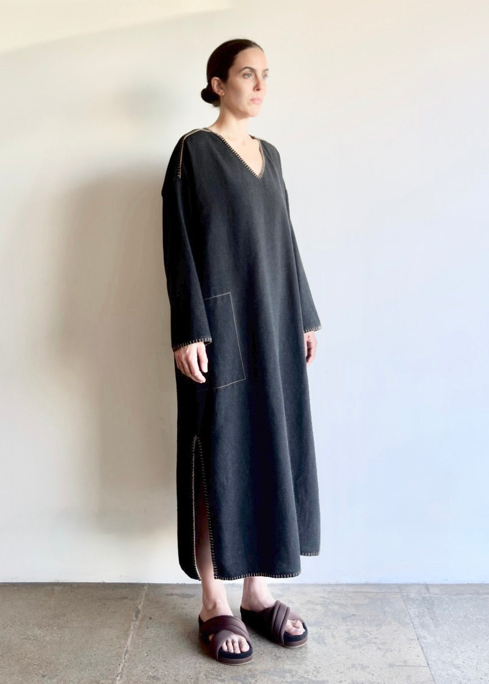 Flannel Poet Dress in soft rayon–cotton blend, shown in front to side view with V-neckline, side pocket, slit and long sleeves.