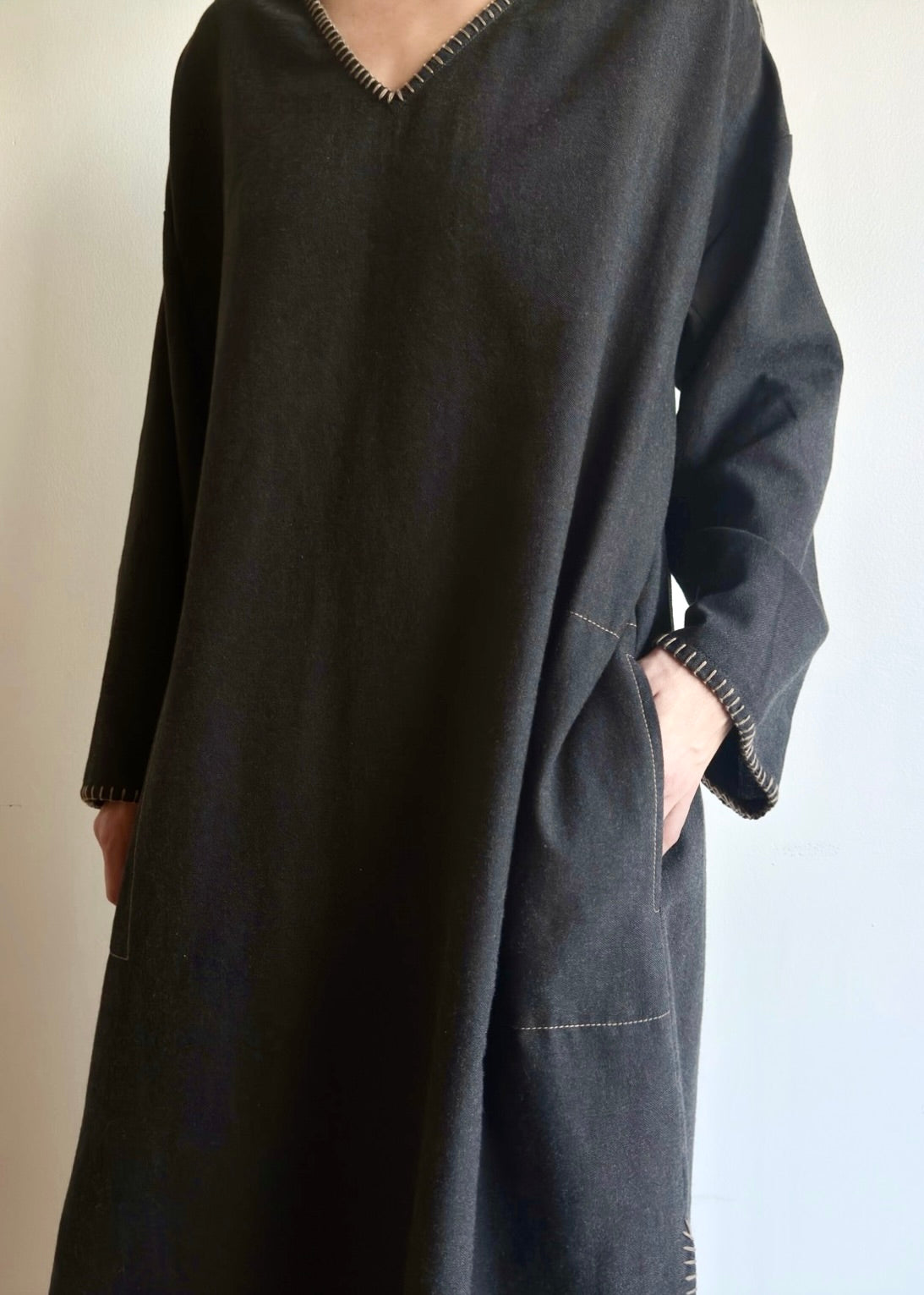 Front 3/4 image of model in the Flannel Poet Dress in-seam pocket and hand-finished edge stitching.
