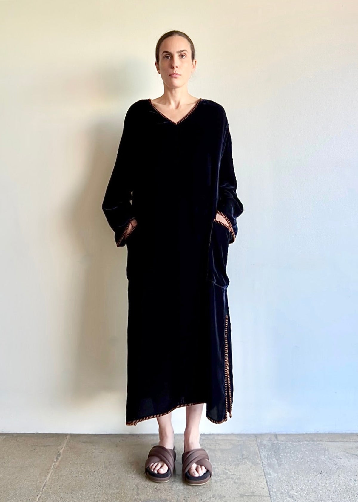 Velvet Poet Dress in cotton–tencel velvet, shown in front view with V-neckline and long sleeves, hands in patch pockets