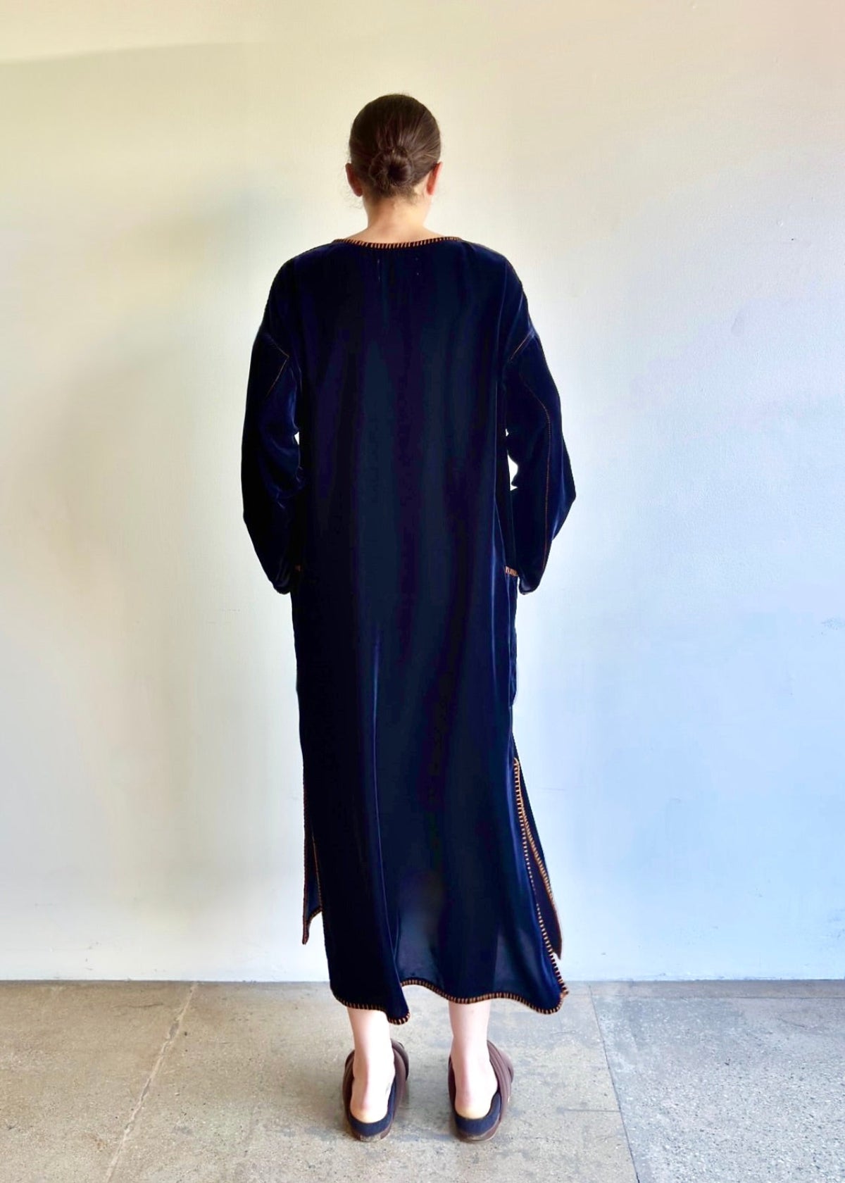 Back view of the Velvet Poet Dress, featuring long sleeves and long, uninterrupted line from neck to hem.
