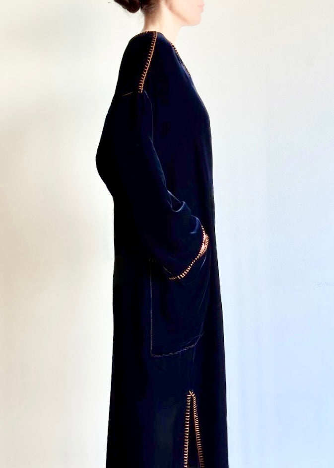 Side view of the Velvet Poet Dress, showing fluid drape, patch pocket, side slit, and subtle sheen of cotton–tencel velvet.