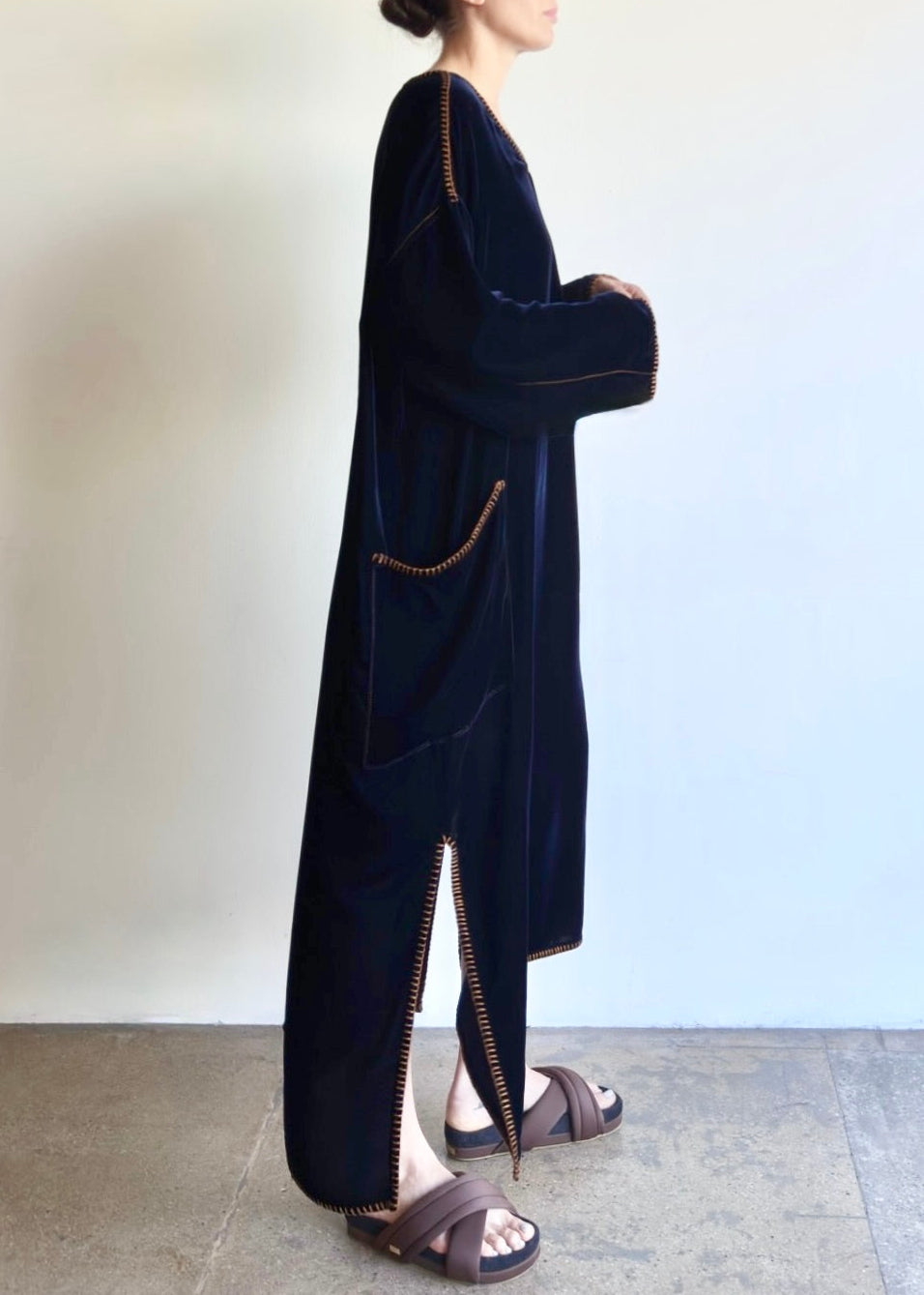 Side view of the Velvet Poet Dress, showing fluid drape, patch pocket, side slit, and subtle sheen of cotton–tencel velvet.