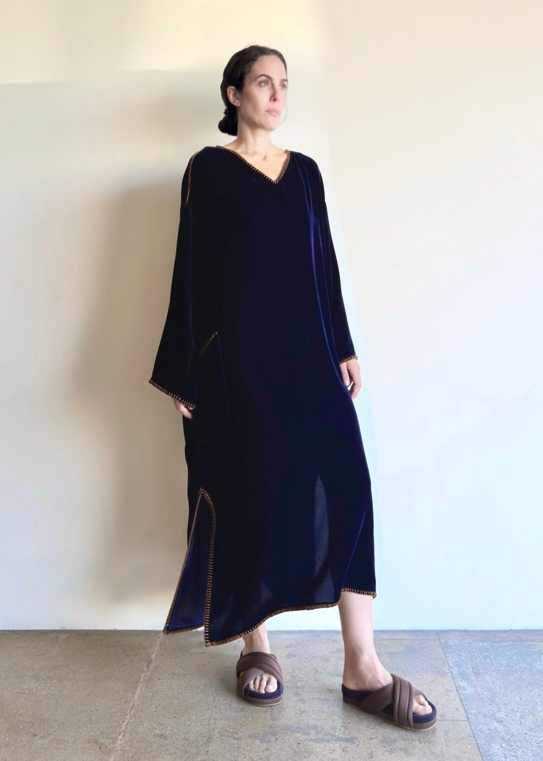 Velvet Poet Dress styled simply, showing elegant drape, v-neck and luminous texture in motion.