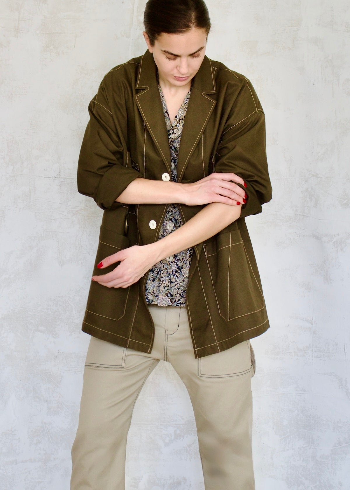 green cotton utility jacket buttons oversize with sleeves rolled and pushed up