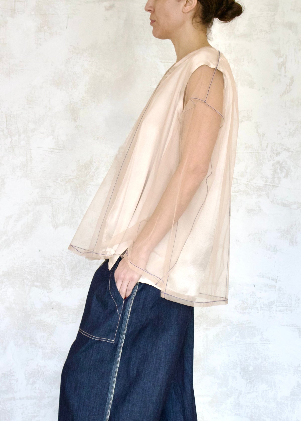 pink tulle top over camisole with denim jeans