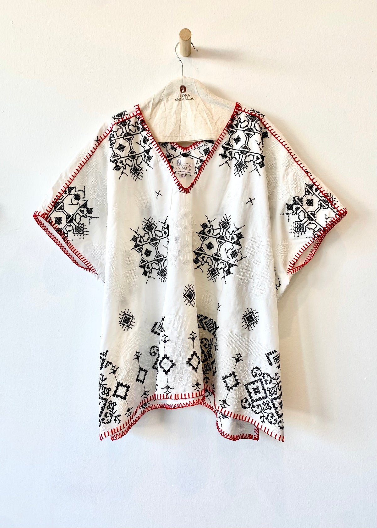 white embroidered tunic with red blanket stitching short sleeves
