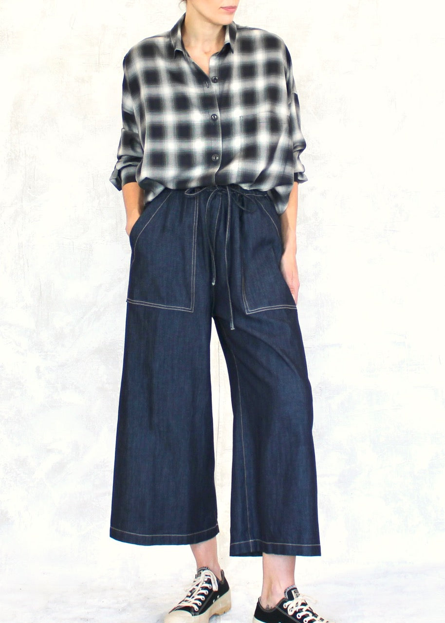 pink tulle top over camisole with denim jeans