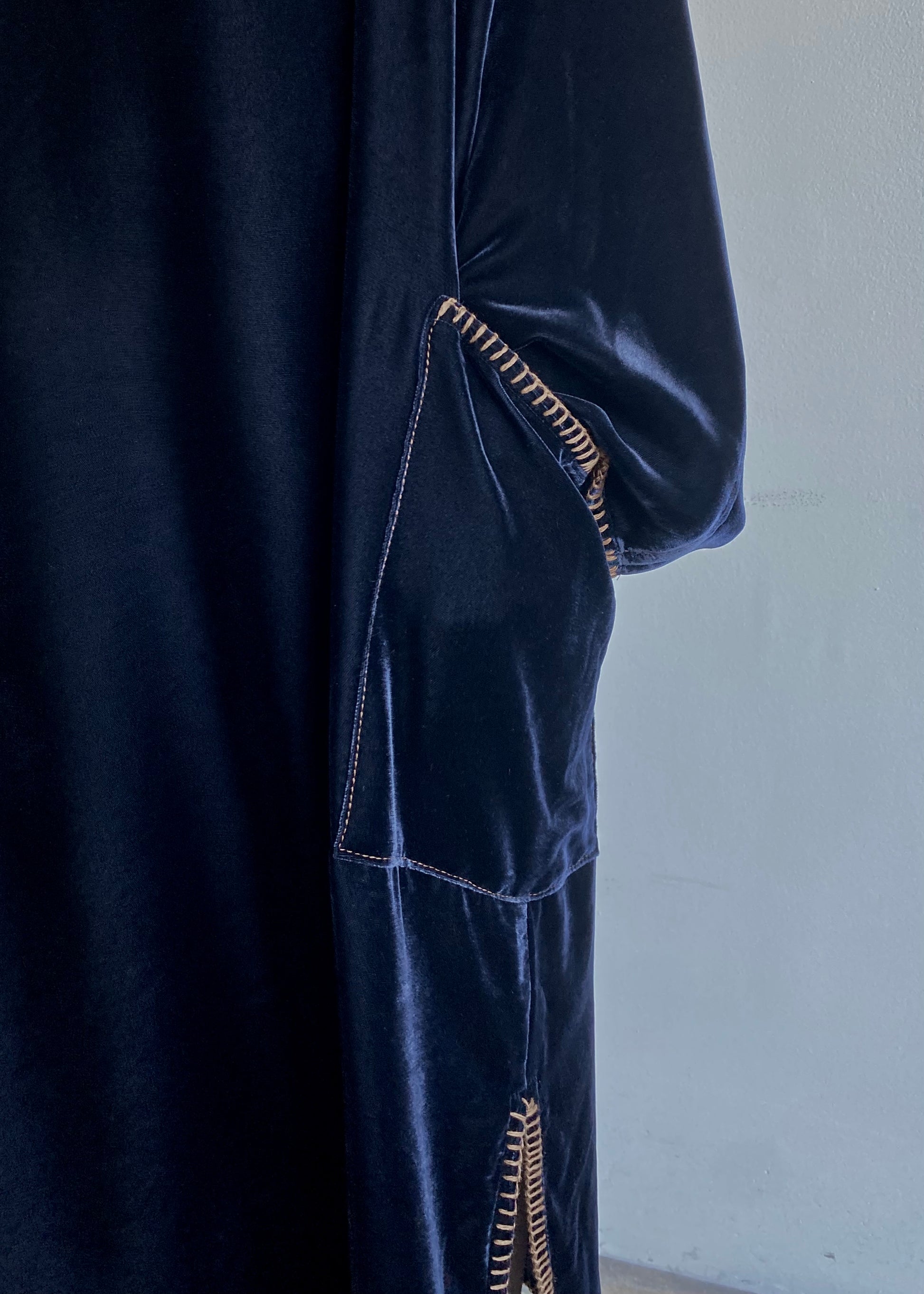 Hand in patch pockt detail of the Velvet Poet Dress with contrast stitching and hand-finished edge.