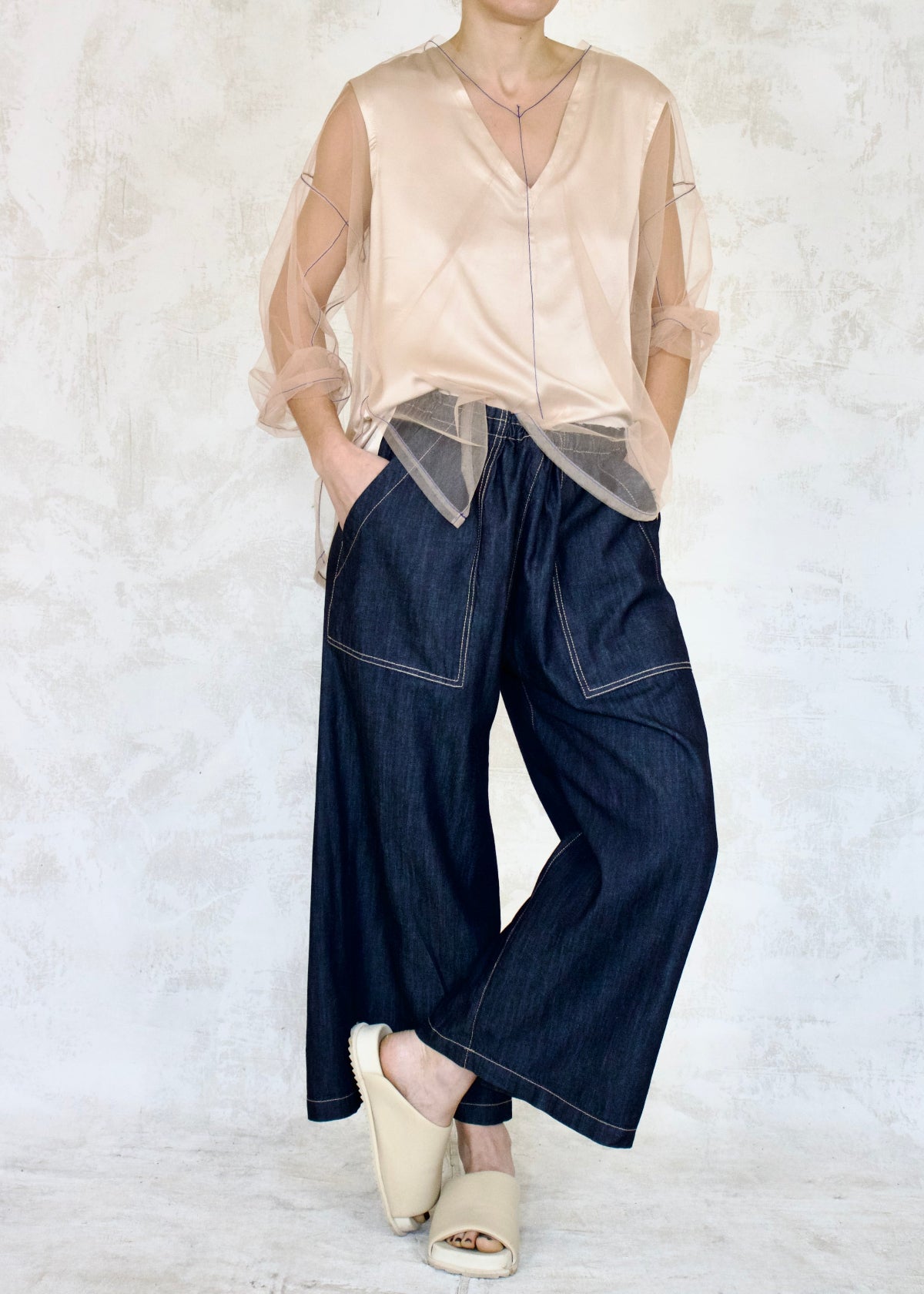 pink tulle top over camisole with denim jeans