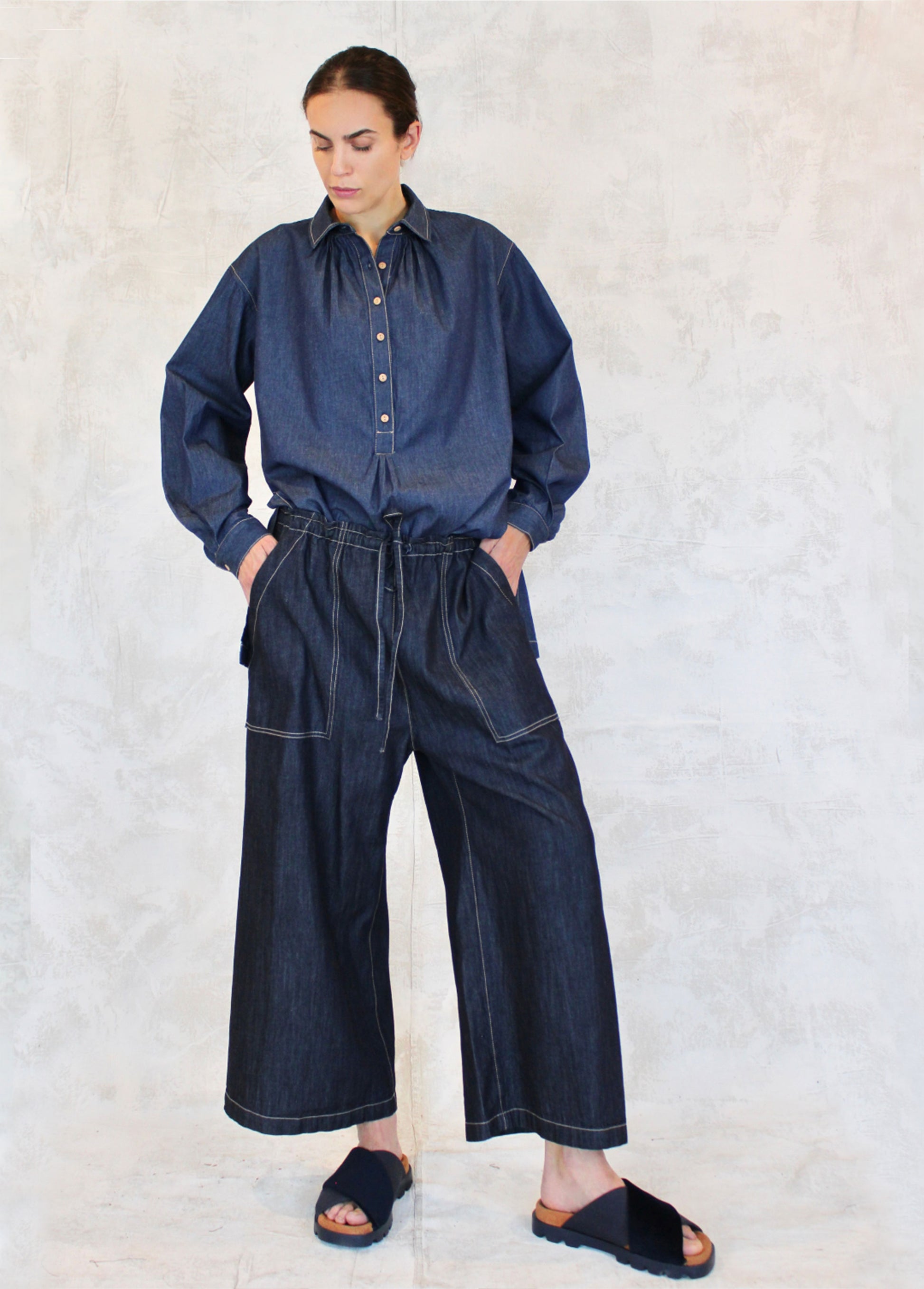 button collared denim top tucked into denim drawstring wide legged pants