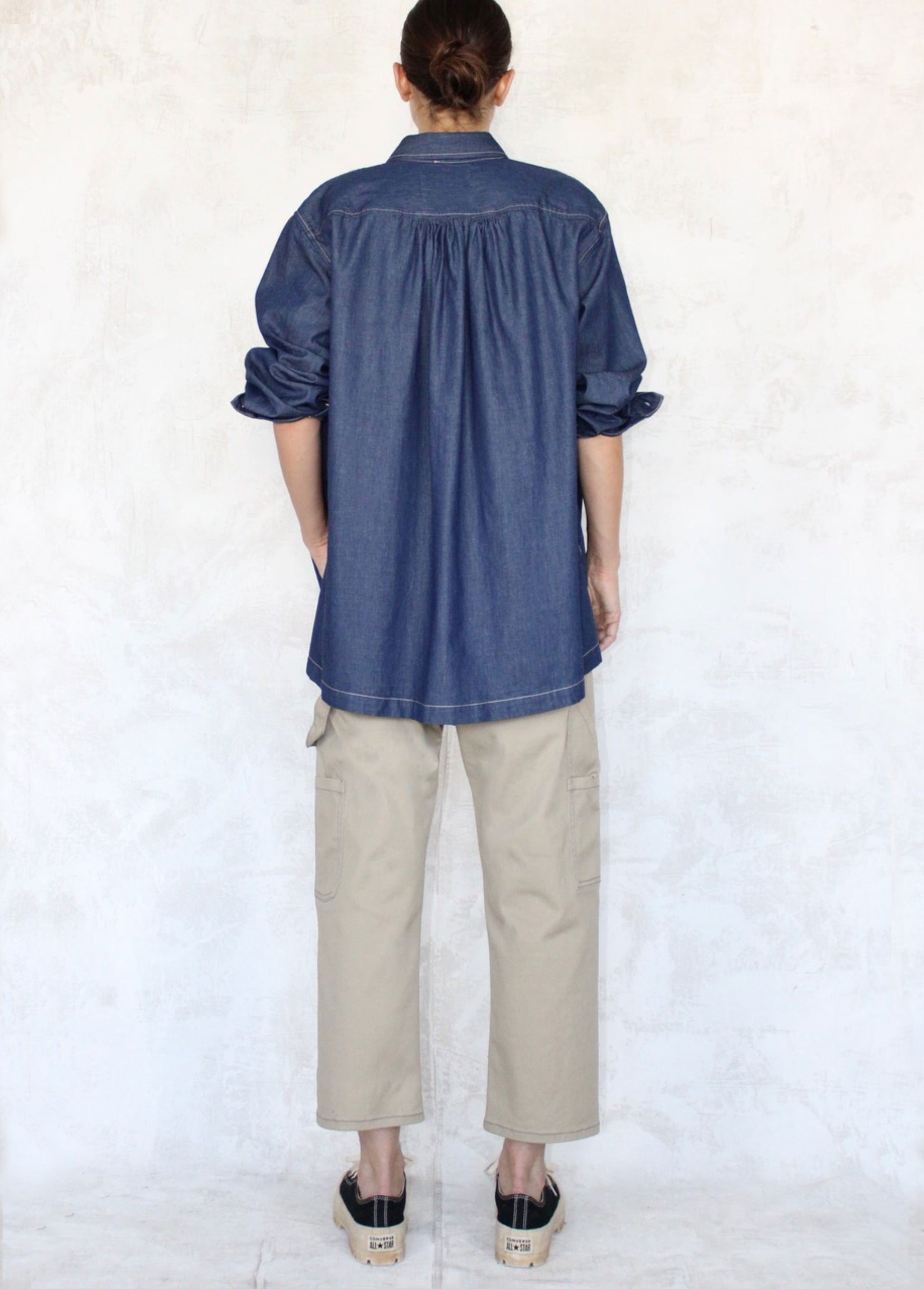 rear view denim drapey top with beige cropped pants