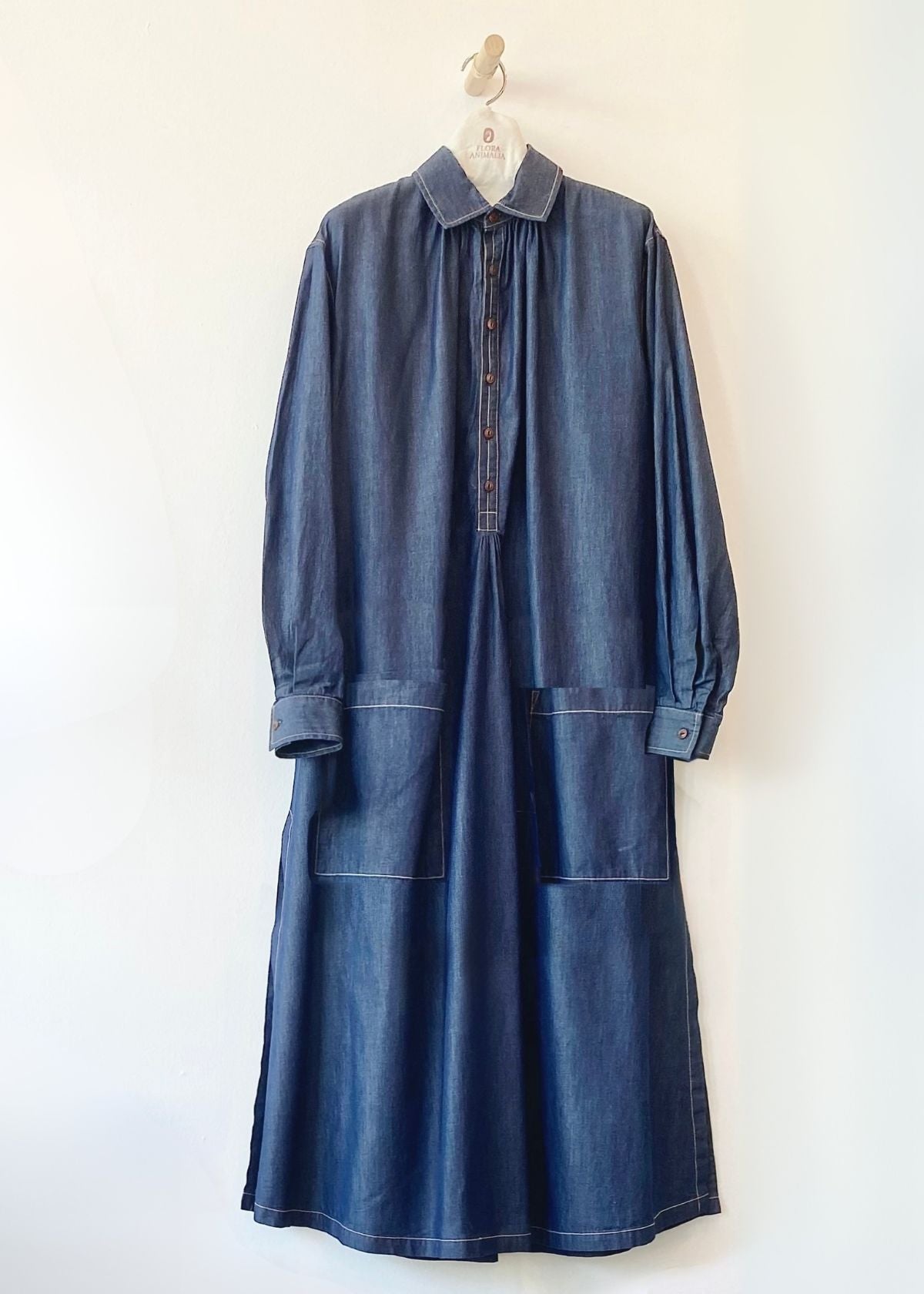 Blue denim Agnes dress with open collar and rolled sleeves on a white background