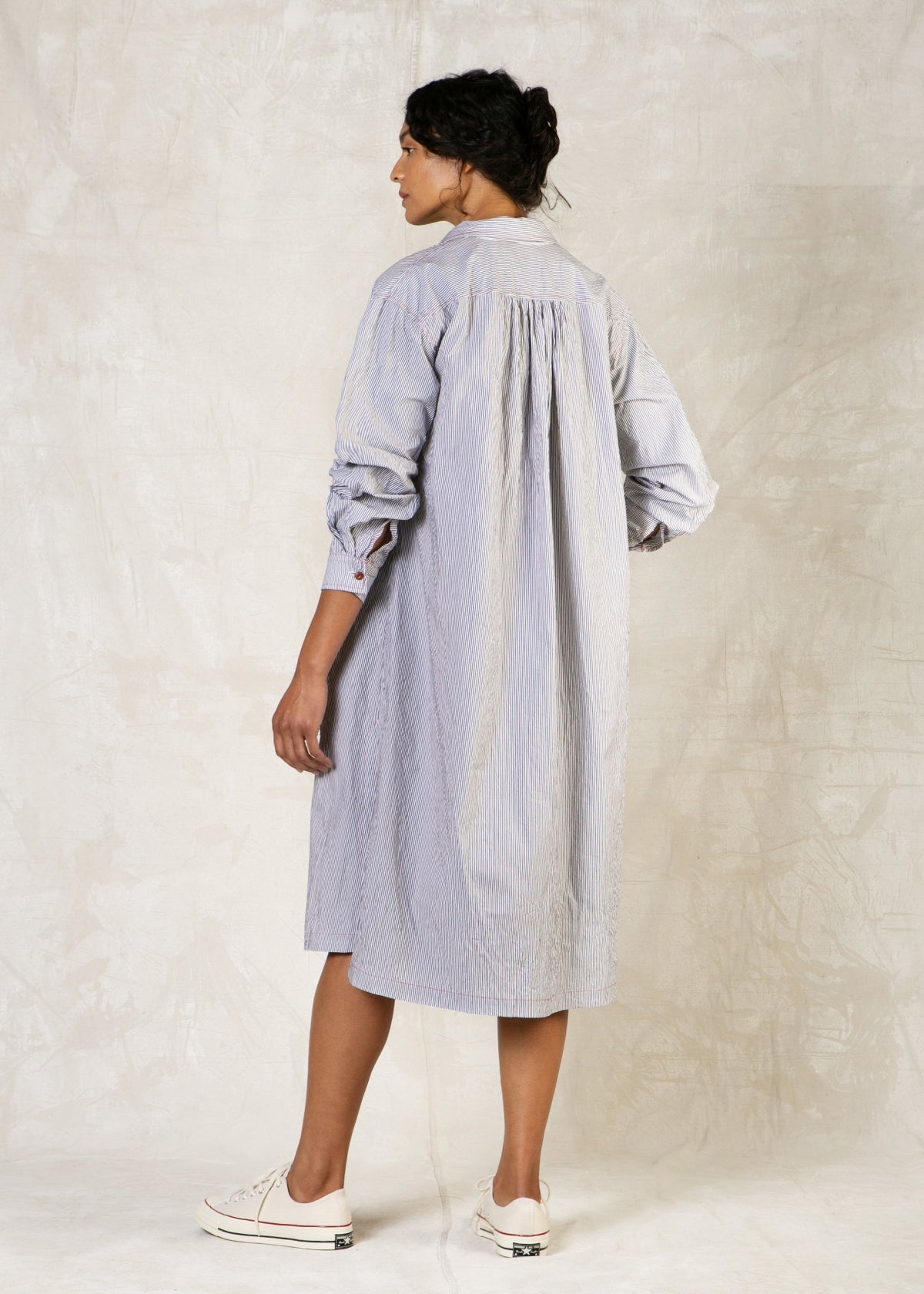 rear view model in light blue shirt dress