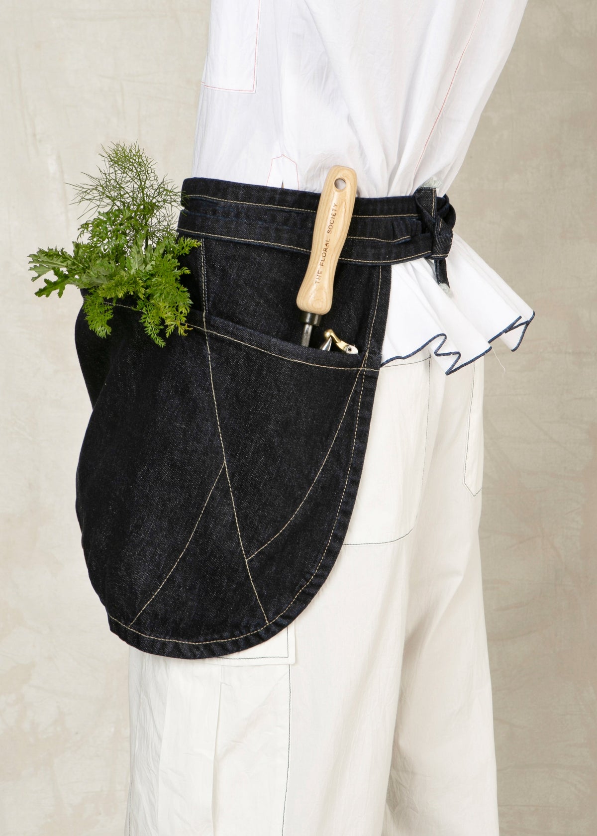 short denim apron with large front pouch pocket close up
