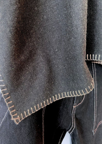 Close-up of dark brown flannel fabric with visible stitching