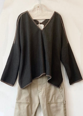 gray  v-neck Praia top with tan trim on a hanger against a white background