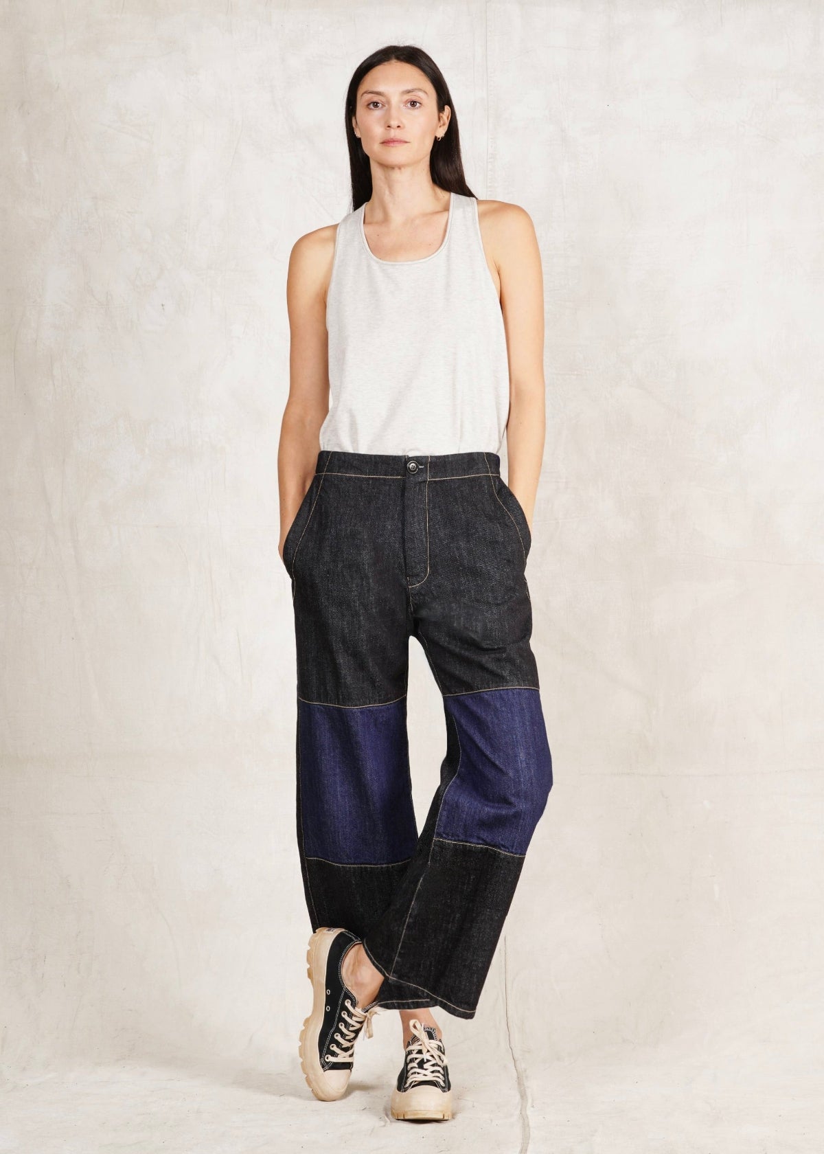 sleeveless top and the Denim Two Tone Artist Pant, which is cropped, has a subtle flare, and is a relaxed fit. The pants are predominantly dark blue with a lighter blue denim mid leg