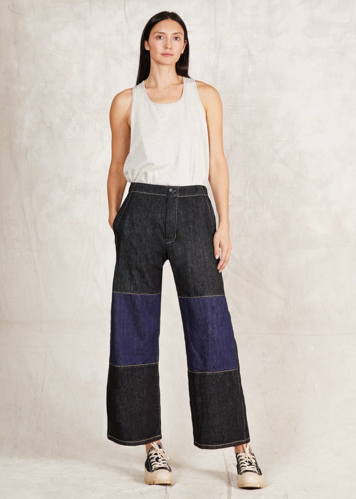 sleeveless top and the Denim Two Tone Artist Pant, which is cropped, has a subtle flare, and is a relaxed fit. The pants are predominantly dark blue with a lighter blue denim mid leg