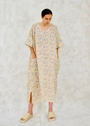 Woman wearing a floral dress on a textured white background