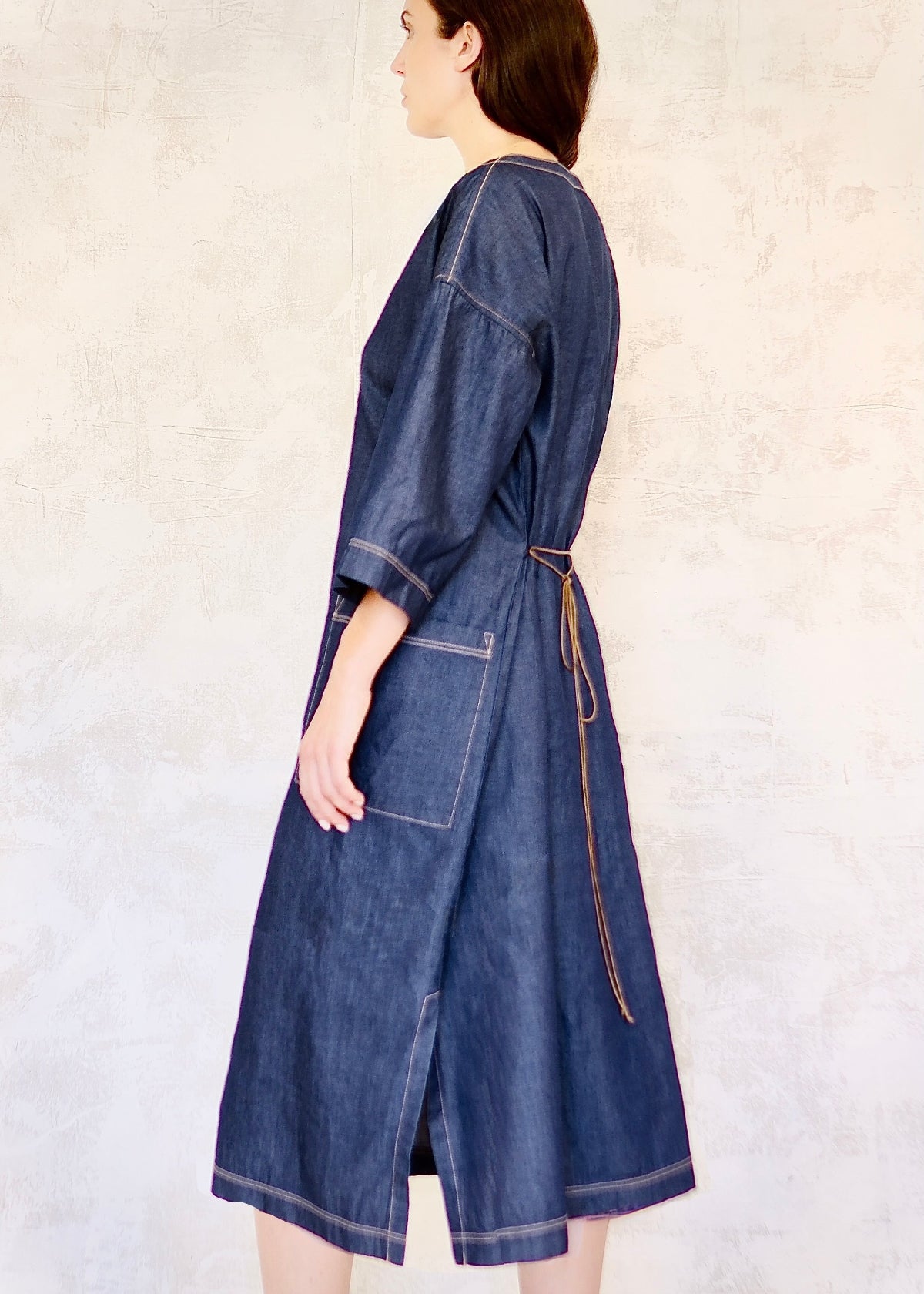 denim dress with belt tied in back and pocket side view