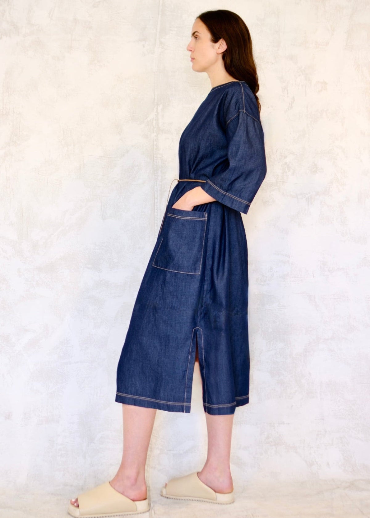 denim dress with cord belt and hand in pocket side view