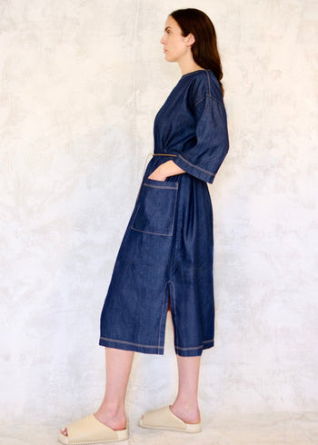 denim dress with cord belt and hand in pocket side view