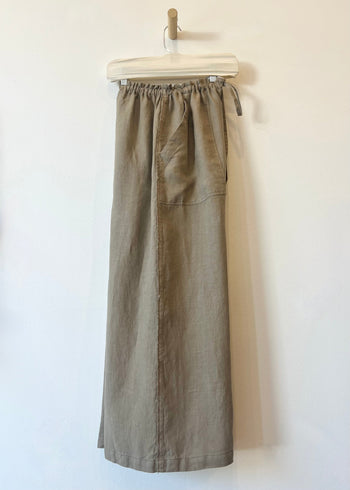 Brown pants on a hanger against a white background