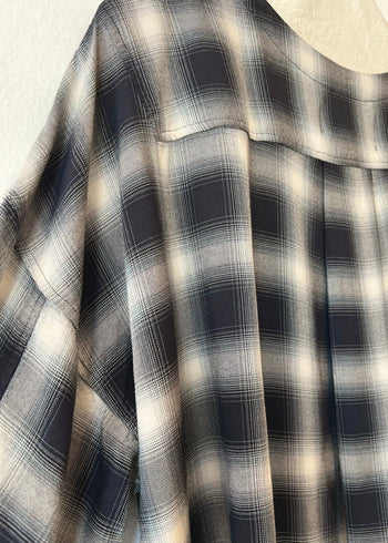 Close-up of a black and white plaid pattern fabric shoulder detail 