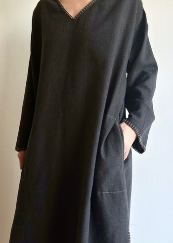 Front 3/4 image of model in the Flannel Poet Dress in-seam pocket and hand-finished edge stitching.