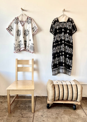white embroidered tunic and black embroidered dress