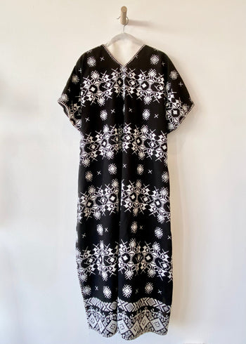 v-neck black caftan with white embroidery blanket stitch detail - back view