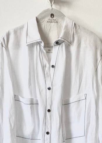2 pocket White button shirt with black accents on a hanger with 'Flora Animalia' label.