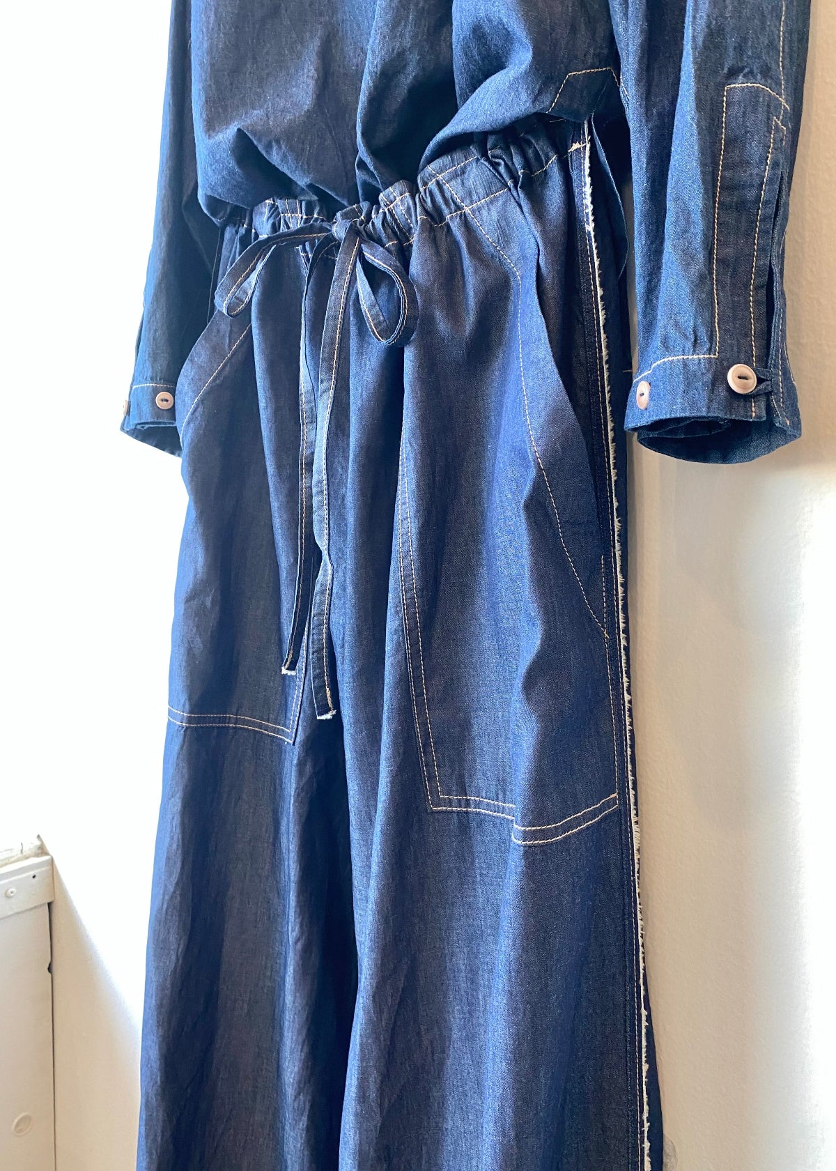 Blue denim outfit with shirt and pants on a white background