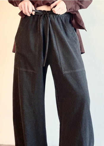 Charcoal Gray Picker's drawstring pants on a model with a plaid shirt on a white background