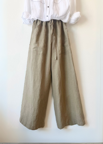 khaki wide-leg pants with a white shirt on a white background